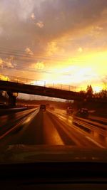 Cars on road at sunset