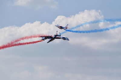 Low angle view of airshow against sky