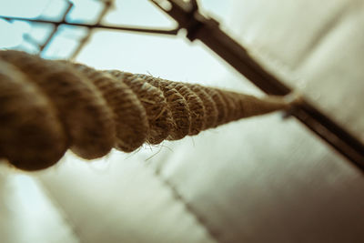 Close-up of rope tied to metal fence