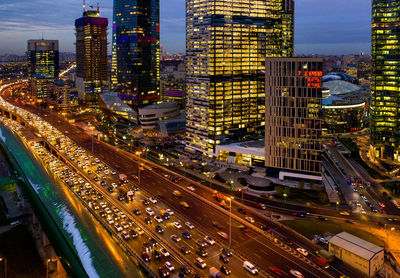 High angle view of illuminated city street and buildings at night