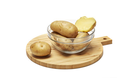 High angle view of bread in container on table against white background
