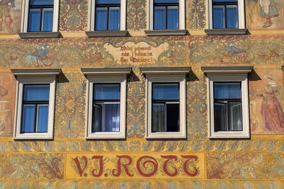 Low angle view of yellow windows on wall