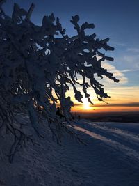 Scenic view of snow field against sky during sunset