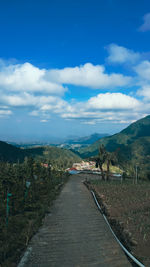 Road amidst landscape against sky
