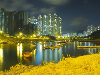 Illuminated cityscape against sky at night