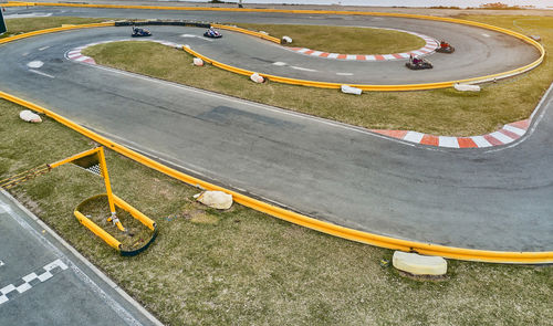 Aerial top view of the go-kart track from the drone. kart racers drive on the open track.