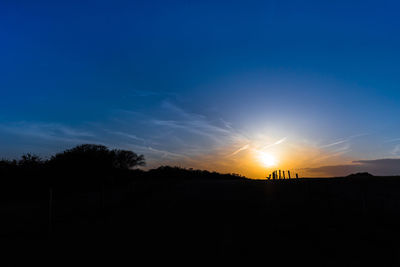 Scenic view of silhouette landscape against sky at sunset