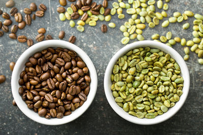 High angle view of roasted coffee beans in bowls on table