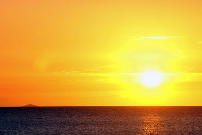 Scenic view of sea against orange sky