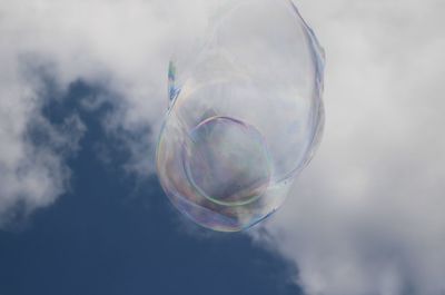 Low angle view of bubbles against sky