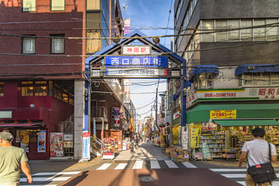 Blue metal entrance gate of the shopping street from the west exit of kanda station.