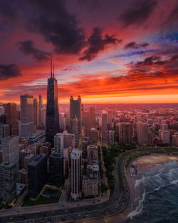 Aerial view of cityscape against sky during sunset