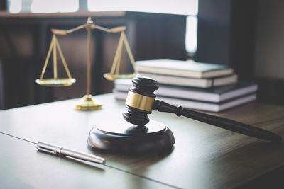 Close-up of gavel on table at courtroom