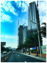 City street against cloudy sky