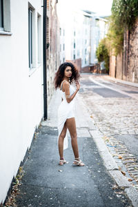 Full length of woman standing on street in city