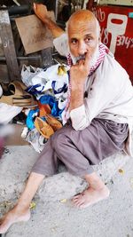 Portrait of woman with dog sitting outdoors