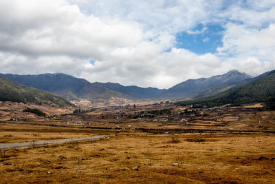 Scenic view of landscape and mountains against sky
