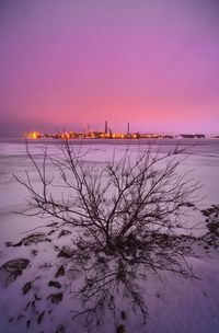 Scenic view of frozen sea against sky at sunset