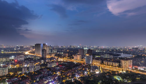 High angle view of city lit up at night