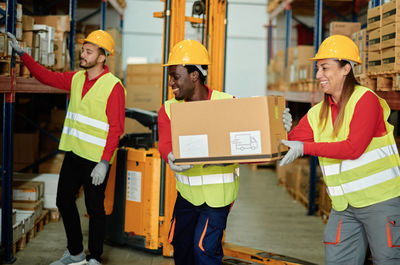 Workers loading parcel in warehouse