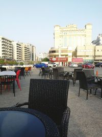 Buildings in city against clear sky