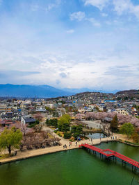 High angle view of townscape and river against sky