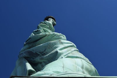 Low angle view of statue against clear blue sky