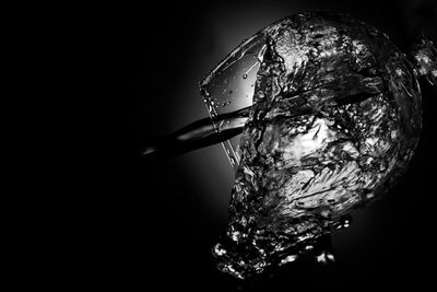 Close-up of water drop against black background