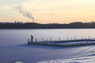 Man by frozen lake