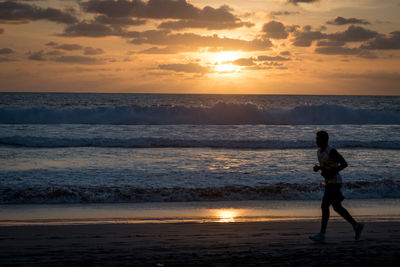 Jogging at sunset beach