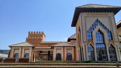 Low angle view of building against clear blue sky