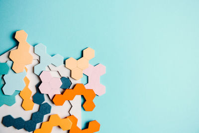 Close-up of jigsaw pieces on blue table