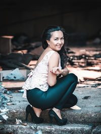 Portrait of smiling young woman sitting outdoors