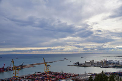 View of harbor against cloudy sky