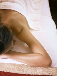 Close-up of woman lying on table at spa