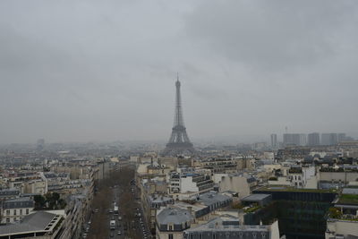 Eiffel tower in city against sky