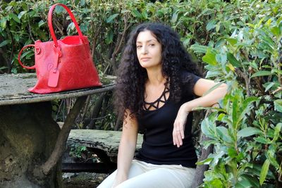 Portrait of young woman sitting outdoors