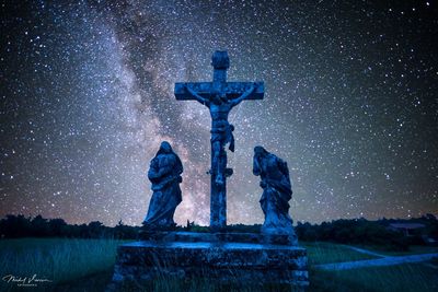 Statue against sky at night