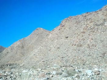 Low angle view of mountain against clear blue sky