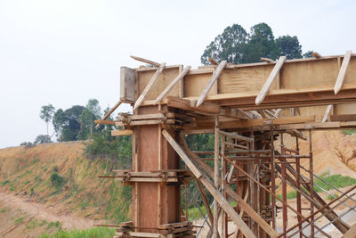 Low angle view of old built structure on field against sky