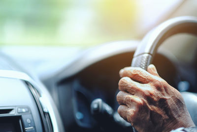 Cropped image of man driving car