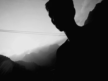 Portrait of silhouette man standing on mountain against sky