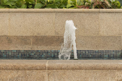 Fountain against white wall