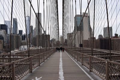 Brooklyn bridge in city against sky