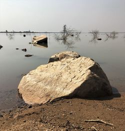 Rocks on beach against sky