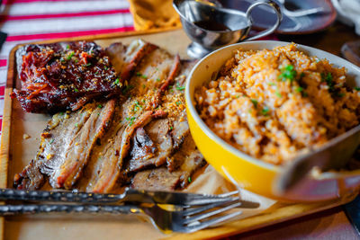 Grilled ribs and prok belly striped served with sauce and java rice.