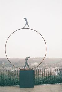 Bird perching on a sculpture