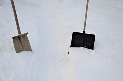 High angle view of coathangers hanging on snow