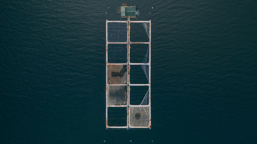 High angle view of salmon cages in the sea
