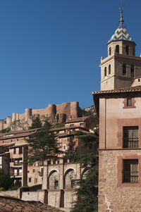 Low angle view of buildings against blue sky